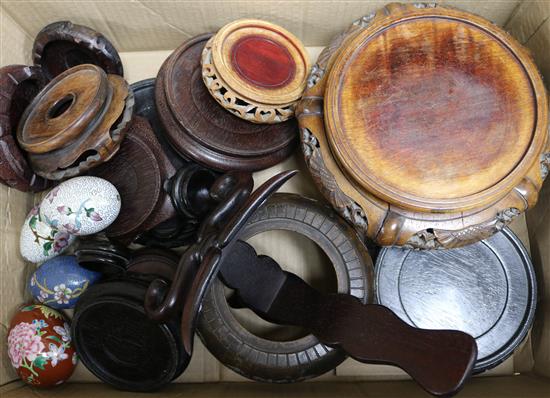 A quantity of wooden Oriental stands and enamel eggs